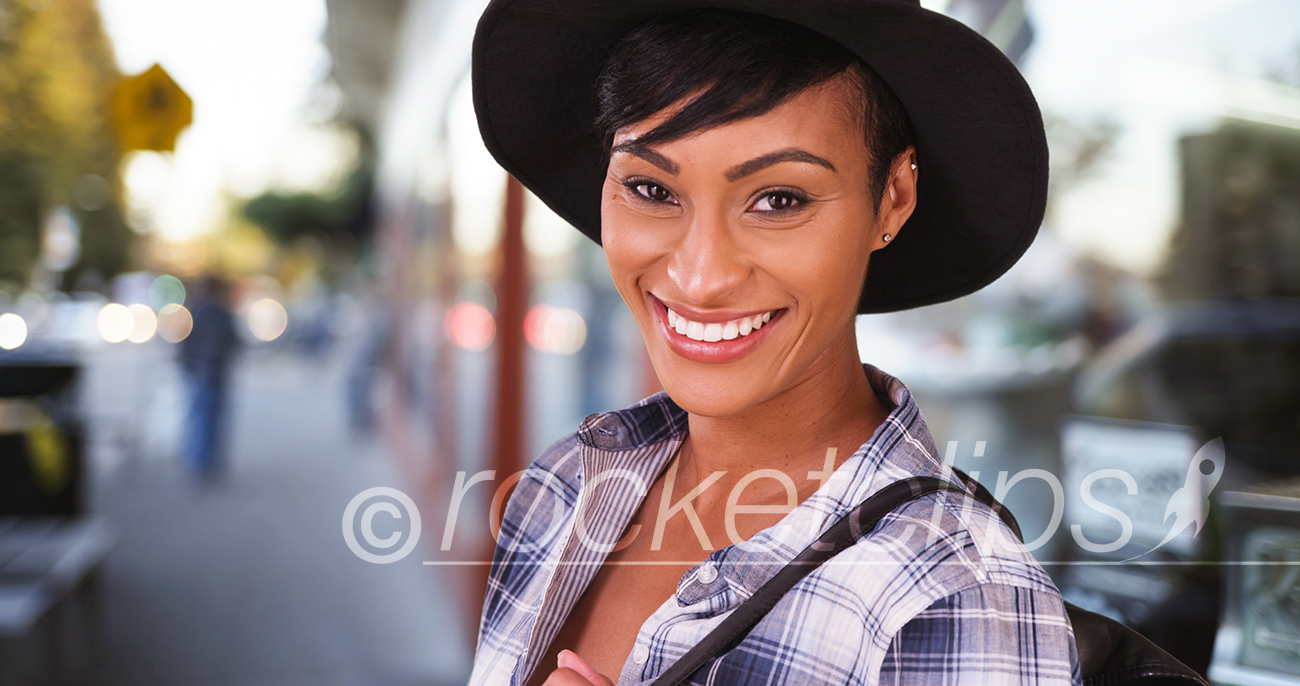 African American woman smiling on busy city street