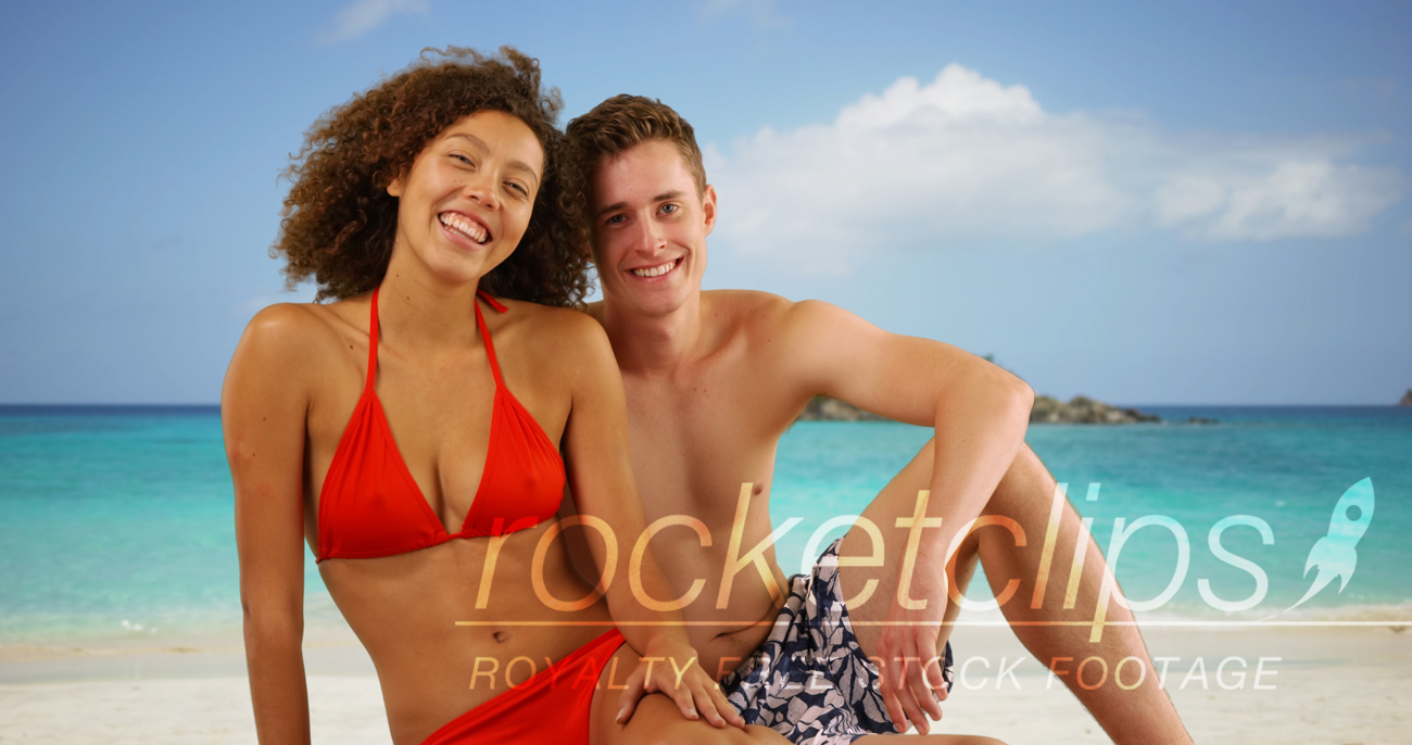 Attractive interracial friends posing on Caribbean beach.