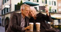 Sweet elderly couple taking selfies outdoors