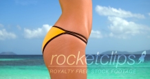 Side view of a millennial white girl in a yellow bikini