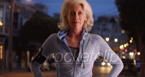 Caucasian female senior out on evening jog posing proudly outside at night