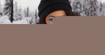 Kind black millennial girl smiling at camera outdoors in snowy setting