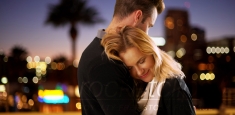 Sweet modern couple hugging outdoors at night