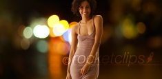 Cute black woman posing with bokeh lights outdoors night scene