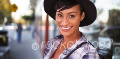 African American woman smiling on busy city street