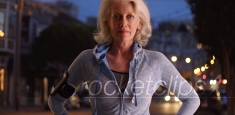 Caucasian female senior out on evening jog posing proudly outside at night